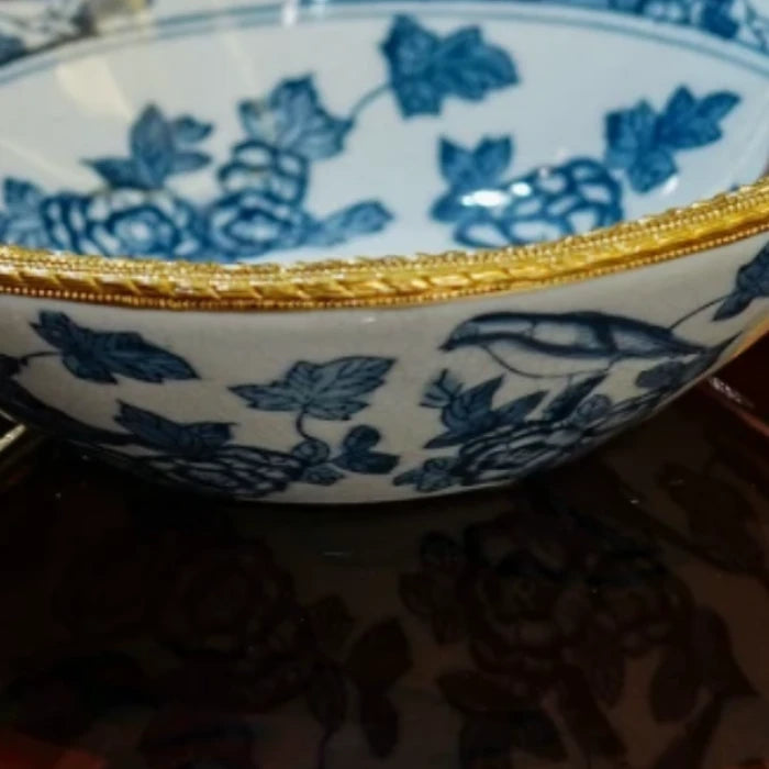Candy dish used as a fruit tray with assorted fruits against a dark background
