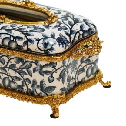 Close-up of brass acanthus leaf details on ceramic tissue box surface