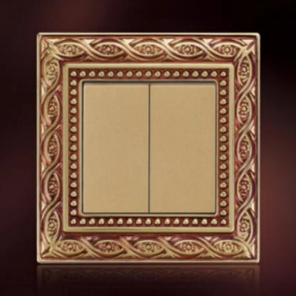 Brass electrical wall plate with ornate border and multi-gang switch configuration