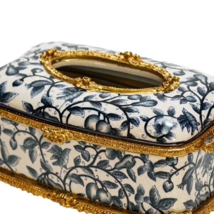 Ceramic tissue box with deep blue floral motifs and elevated brass base