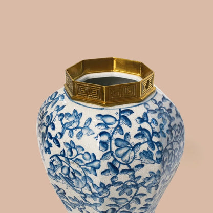Top-down detailed view of a ceramic jar's brass finial lid and geometric collar.