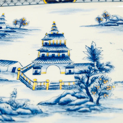 Detailed view of brass edges and supporting feet on decorative tray with ceramic inlay