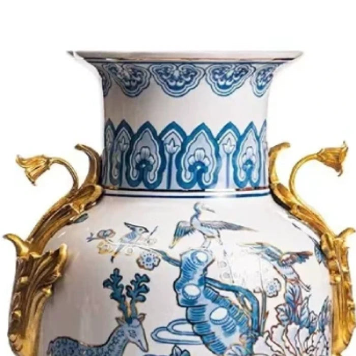 Detailed close-up of a brass dragon head handle on the blue and white vase.