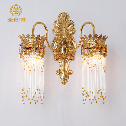  Frontal view of the Aurelia Cascade gold wall sconce showing its ornate backplate and glass rods