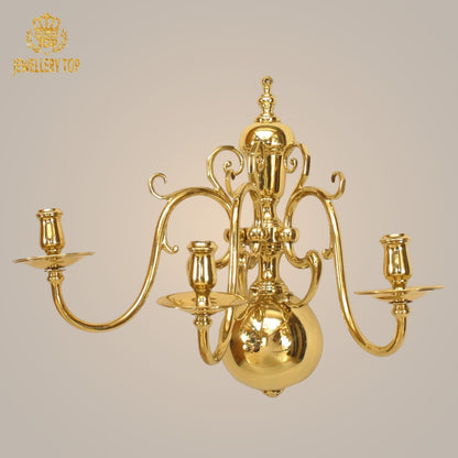 Classic Georgian wall lamp with sleek brass arms and graceful candleholders.