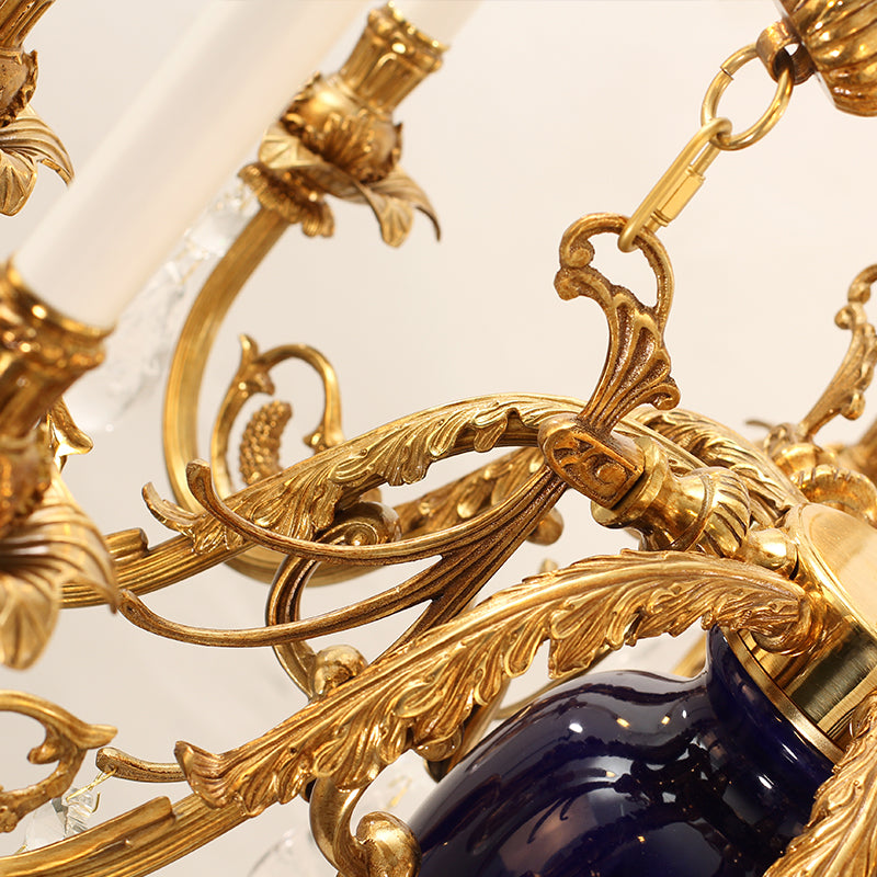 Detail view of deep blue ceramic urn with gilded brass embellishments