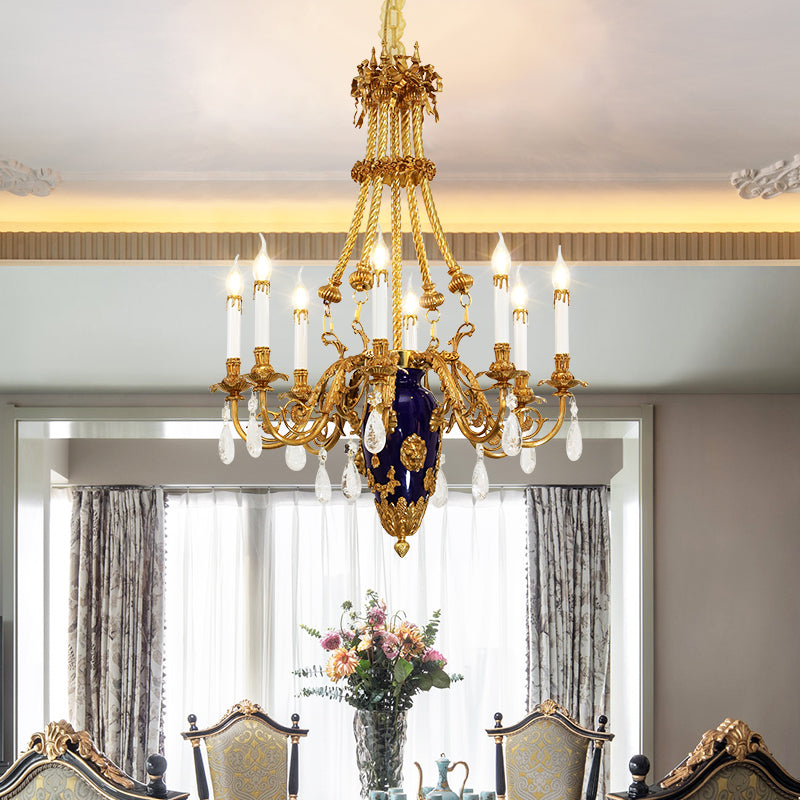 Eight‑arm brass Victorian chandelier suspended from chain with crystal accents