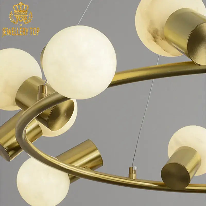 Brass ring chandelier with organic alabaster orbs in a contemporary living room setting
