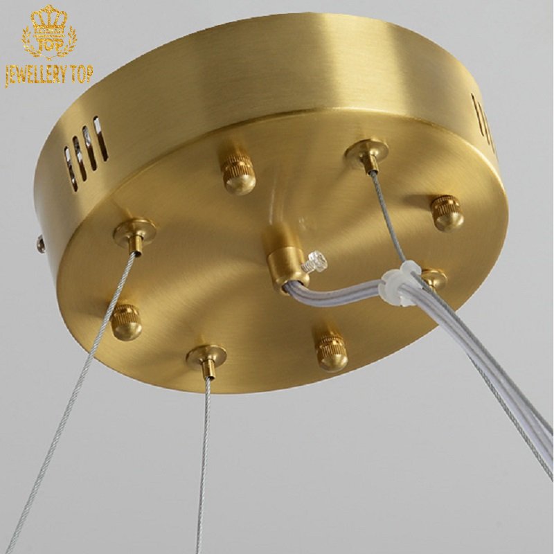 Sustainable chandelier combining recycled brass and ethically sourced natural stone