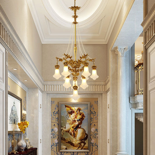 Athena Antique Brass Chandelier suspended in a grand interior with soft ambient lighting.