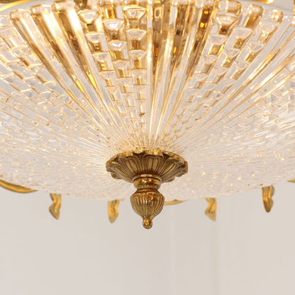 Elegant flush mount brass and crystal light fixture with Neoclassical style.