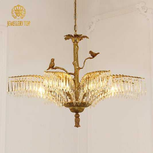 Elegant palm leaf chandelier with bird accents and sparkling crystal drops.