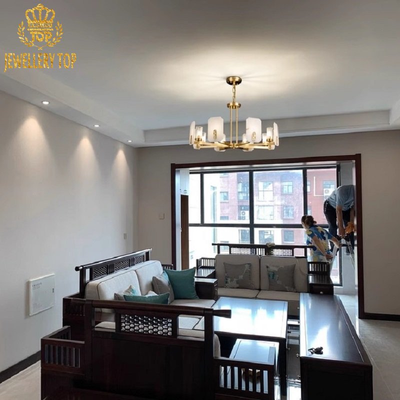 Interlocking chevron brasswork with champagne oxidation finish on luxury lighting