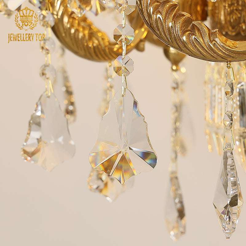 Sunburst crystal refraction on Neoclassical brass chandelier arms