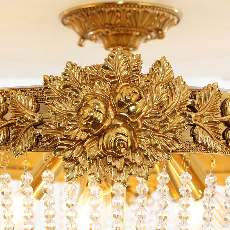Ornate rose and leaf sculpting in antique brass on vintage ceiling light.