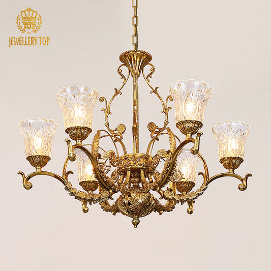 Vintage gold chandelier with ornate brass frame and illuminated glass shades.