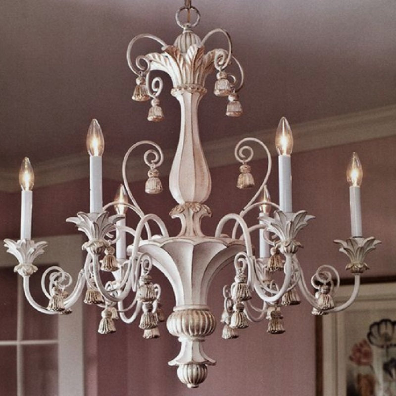 Farmhouse chandelier with wildflower iron arms and linen tassels in a cozy kitchen
