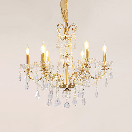 Polished brass arms elegantly curving to support candle-style bulbs.