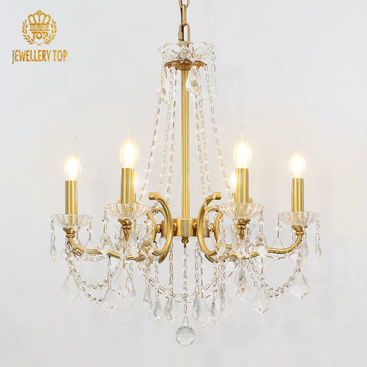 Vintage French chandelier featuring brass arms and crystal accents.