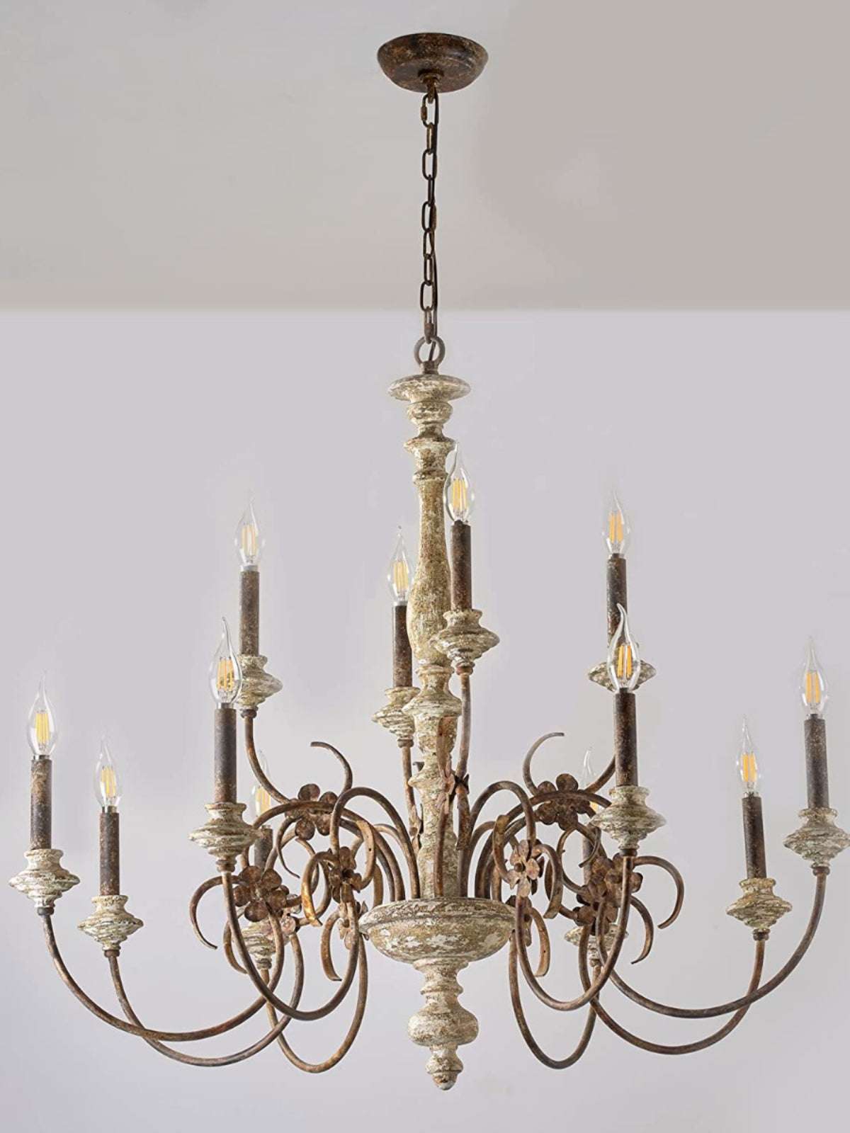 Weathered iron fleur-de-lis details and linen glass shades on farmhouse lighting