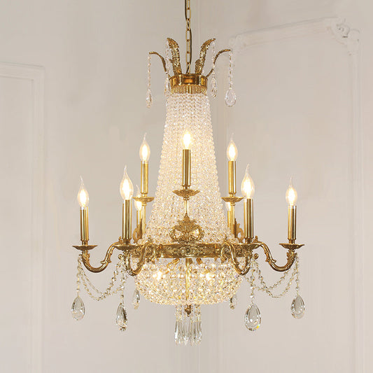 Close-up of gleaming brass framework supporting multiple candle-style lights.