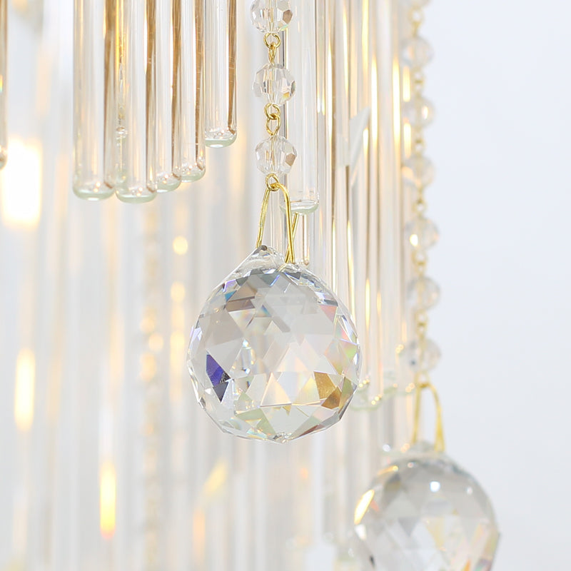 Close-up of detailed crystal droplets on brass chandelier.