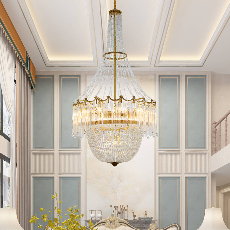 Side view of glass crystals hanging elegantly from brass chandelier frame.