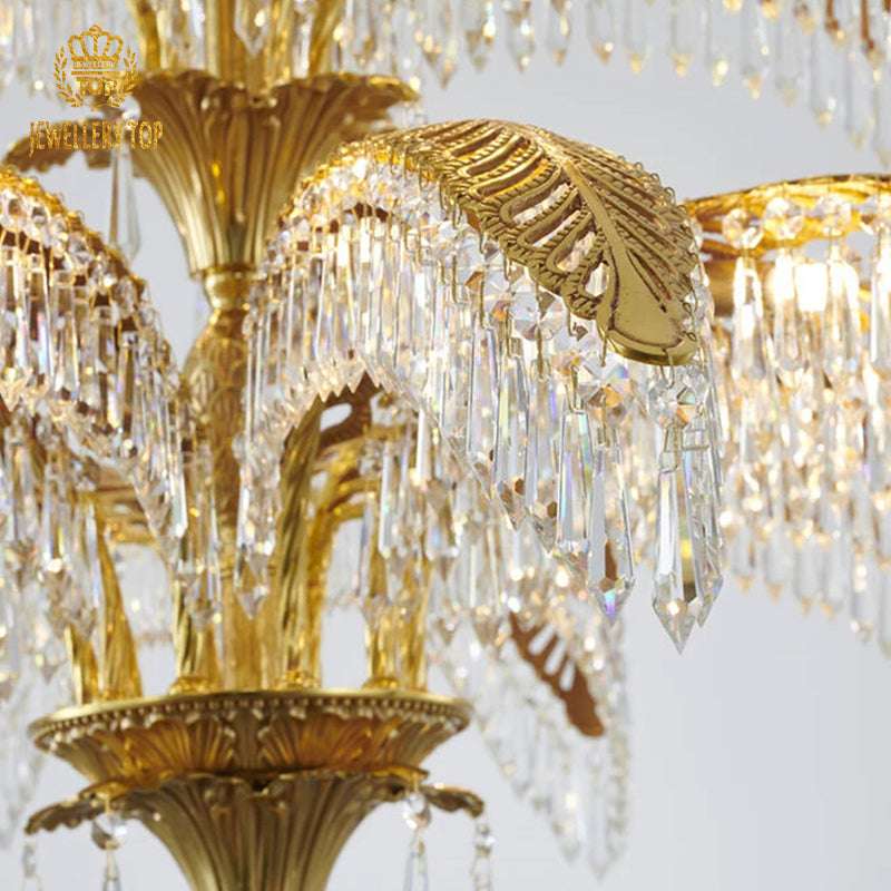 Close-up of the palm leaf chandelier with cascading crystals and golden brass frame.